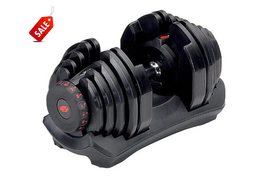 Pair of black Bowflex SelectTech adjustable dumbbells with red accents on weight selector dial, resting in black base stand
