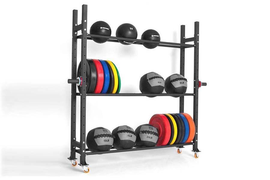 Black steel three-tier weight storage rack with medicine balls, weight plates in red, blue, yellow, and orange, and dumbbells