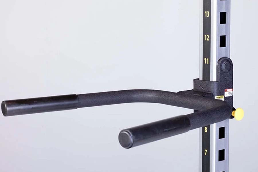 Black powder-coated dip handles attachment with foam grips, mounted on numbered weight rack upright on white background