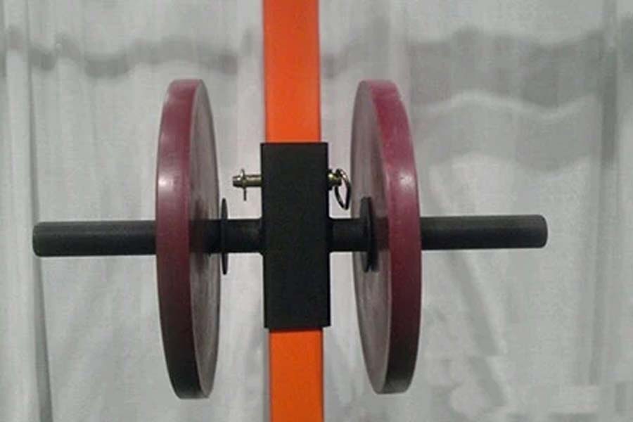 Warrior double weight plate storage attachment with burgundy weight plates on orange and black bar, front view