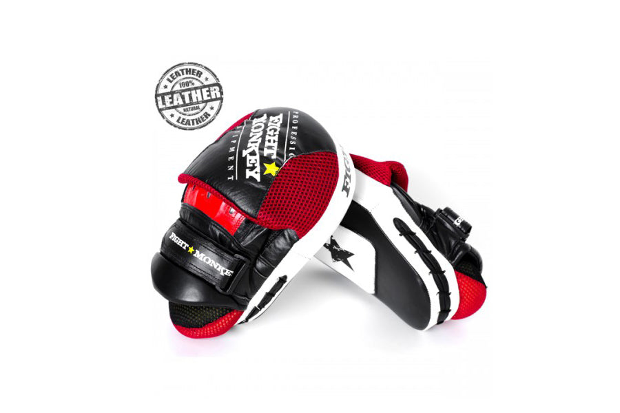 Pair of black, white, and red leather focus mitts with padded red mesh palm, displayed on white background
