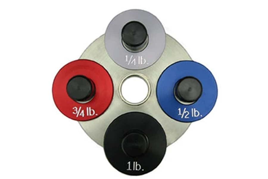 Warrior Fractional Add-On Plates in gray, red, blue, and black with weight labels 1/4lb, 3/4lb, 1/2lb, and 1lb, displayed on