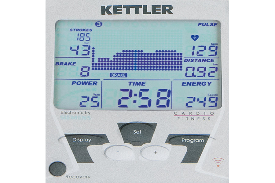 Kettler Coach E rowing machine console with blue digital display showing strokes, pulse, brake, distance, power, time, and en