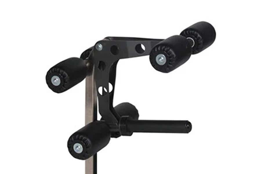 Black and gray multi-purpose squat rack with dual pulleys and foot pedal, viewed against white background
