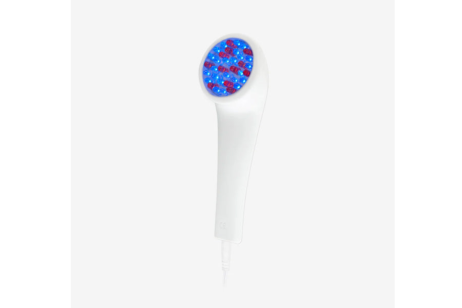 White handheld LED light therapy device with blue and red light head on white background