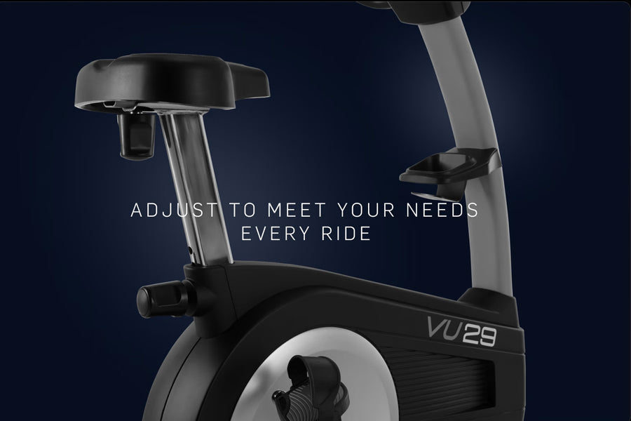 NordicTrack Commercial VU 29 upright exercise bike with gray adjustable seat post and black frame on dark blue background