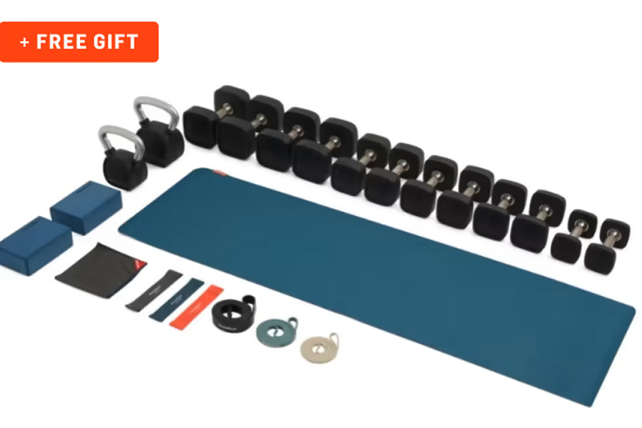 NordicTrack S10i Commercial Studio Bike equipment bundle with teal mat, black kettlebells, resistance bands, and accessories