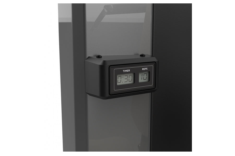 Black digital timer and rep counter display mounted on gray exercise machine frame