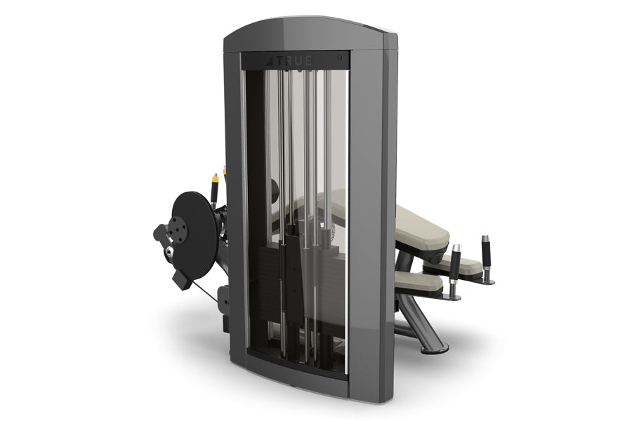 TRUE SPL-1800 horizontal leg curl machine with gray frame, black weight stack, and beige cushioned seat on white background