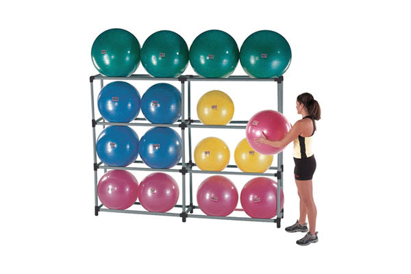 Metal stability ball storage rack with teal, blue, yellow, and pink exercise balls, woman placing ball on shelf