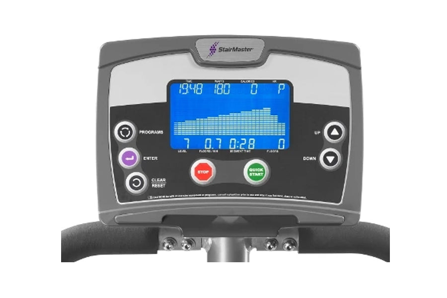 StairMaster SM3 StepMill console with blue digital display showing stats, control buttons, and black handlebar on white backg