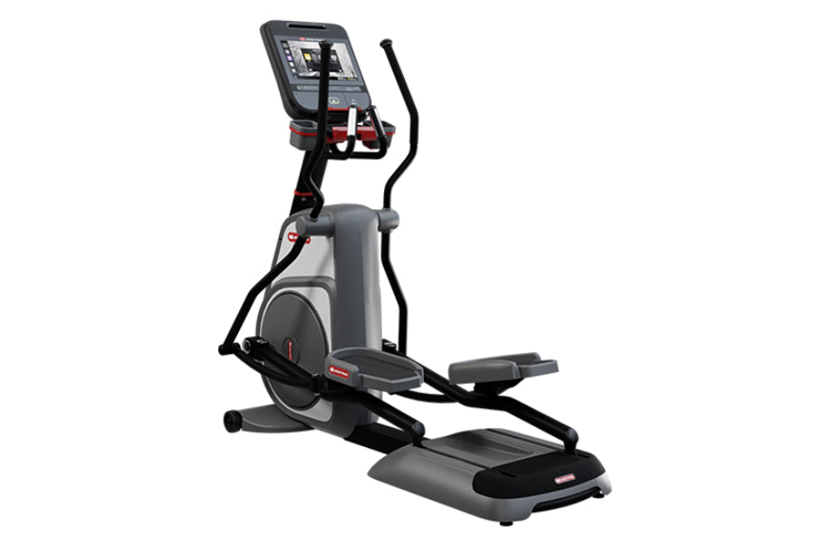 Star Trac 8CT elliptical cross trainer with gray and black frame, digital display console, and dual foot pedals on white back