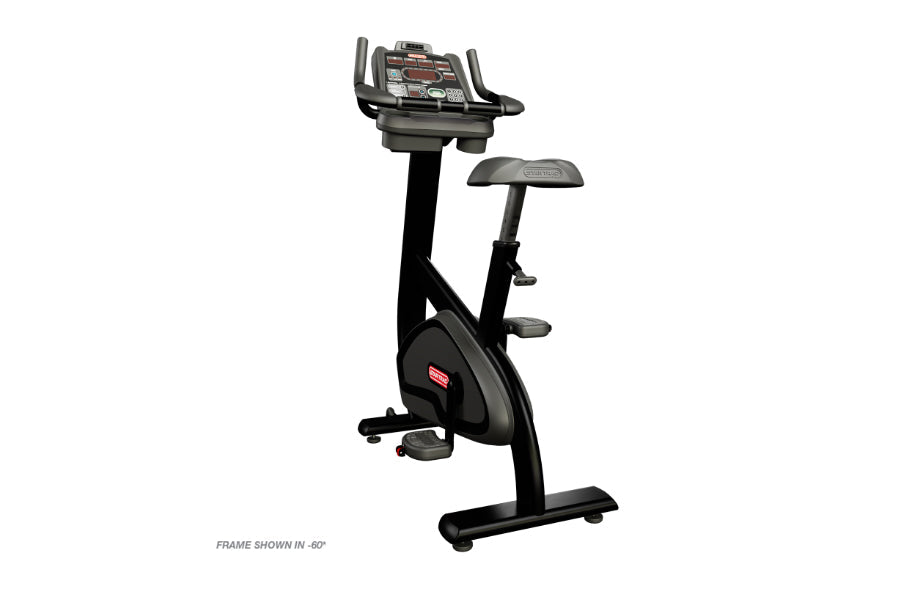Black upright exercise bike with digital console display, adjustable seat, handlebars, and foot pedals on white background