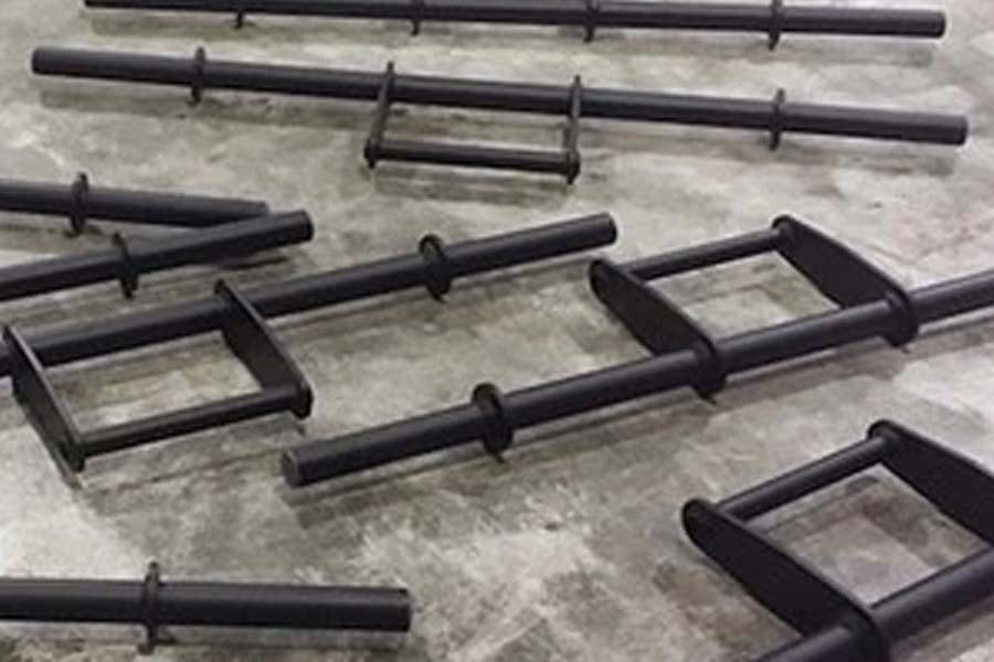 Black steel farmer's walk handles with rectangular frames, displayed on concrete floor