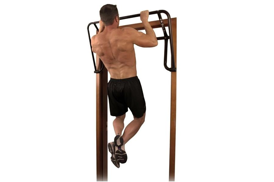 Teeter EZ-Ups inversion and chin-up rack system with wooden posts and black metal frame, demonstrated by shirtless male model
