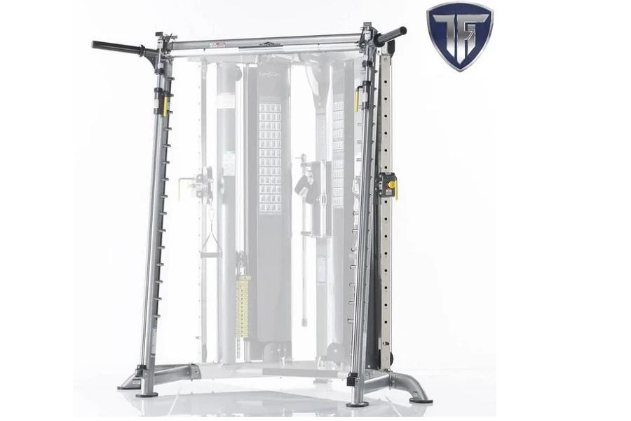 Silver and black multi-functional gym trainer with cable pulleys, Smith press attachment bar, and adjustable weight pegs on w