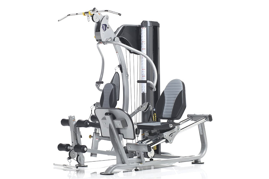 TuffStuff Classic Home Gym multi-station machine with silver frame, black padding, leg press, chest press, and cable system o