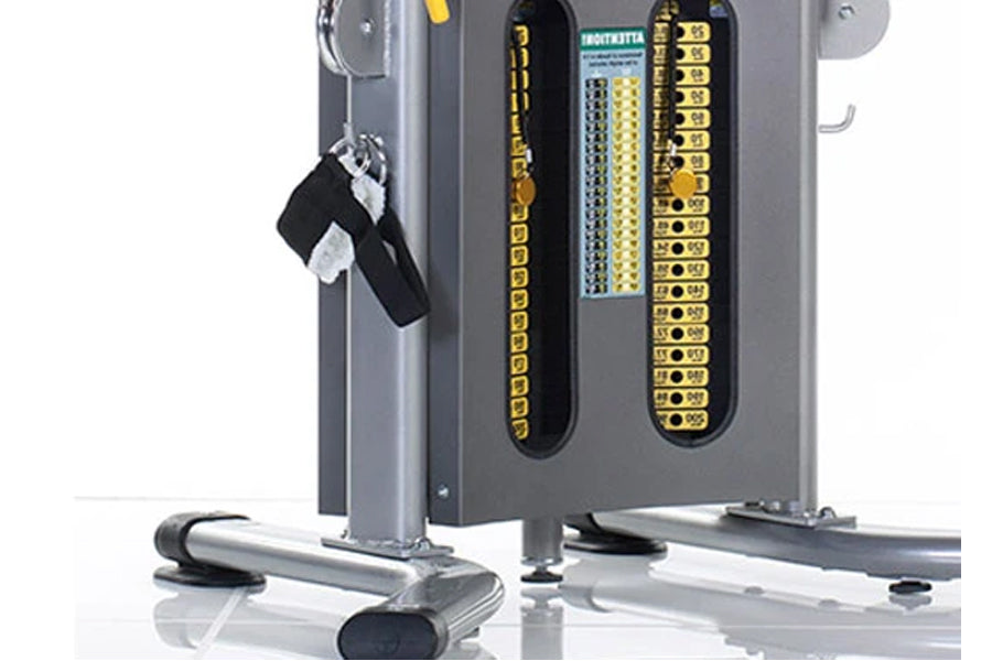 Gray and yellow dual stack functional trainer with black and silver handles, yellow circuit board panels, and rolling base on