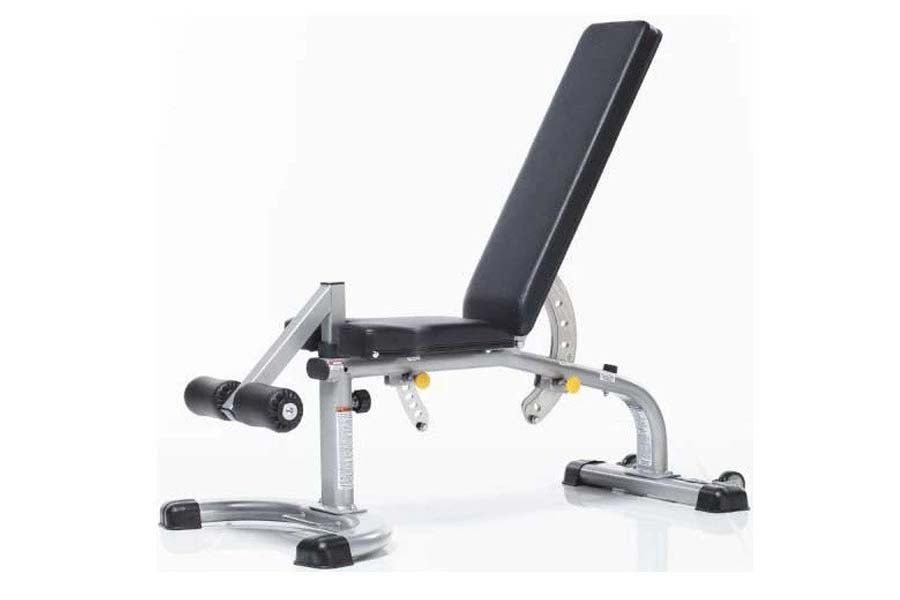 Adjustable weight bench with black padded seat and backrest, silver metal frame, leg extension attachment, and black rubber f