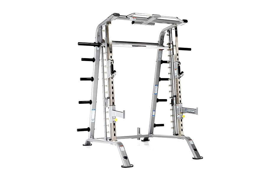 TuffStuff Evolution Smith Machine half cage combo with silver metal frame, black horizontal bars, and adjustable safety catch