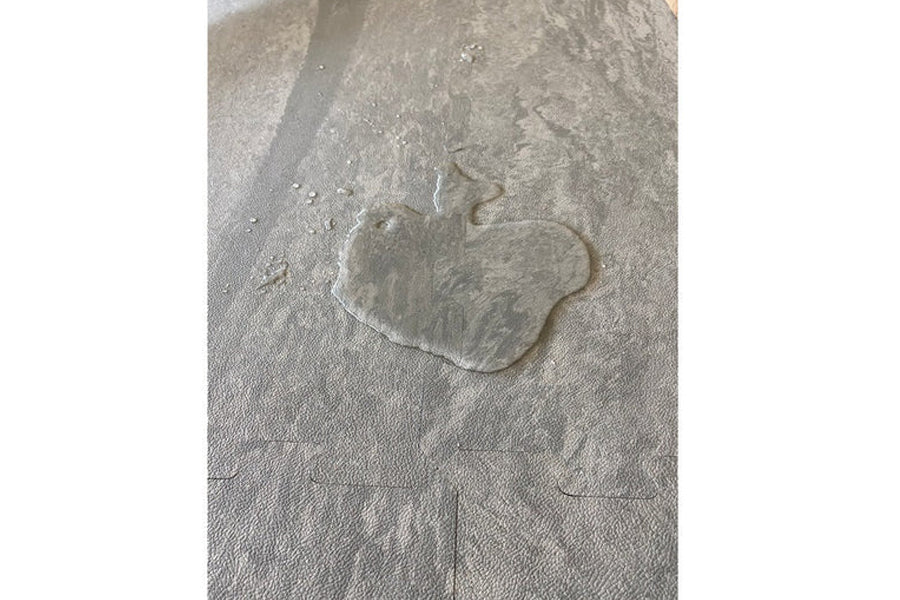 Warrior Marble Interlocking Gym Tile in smoke grey with textured surface, shown flat lay on grey background