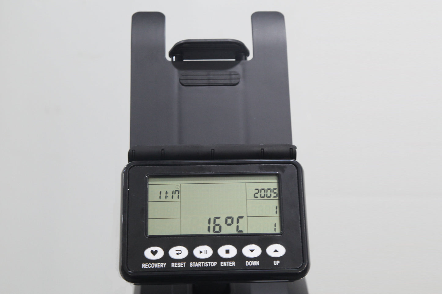 Black rowing machine console with LCD display showing time, distance, and calorie metrics, adjustable arm handles, and contro