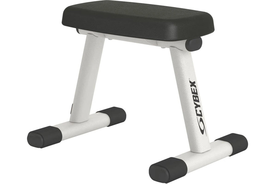Cybex weight training bench with black padded seat, white metal frame, and black rubber feet on white background