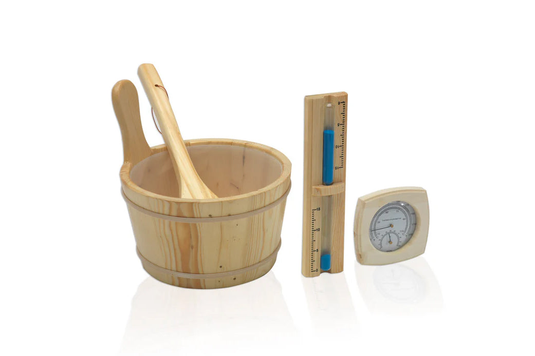 Wooden sauna accessories set including pine bucket with ladle, thermometer with blue liquid indicator, and hygrometer on whit