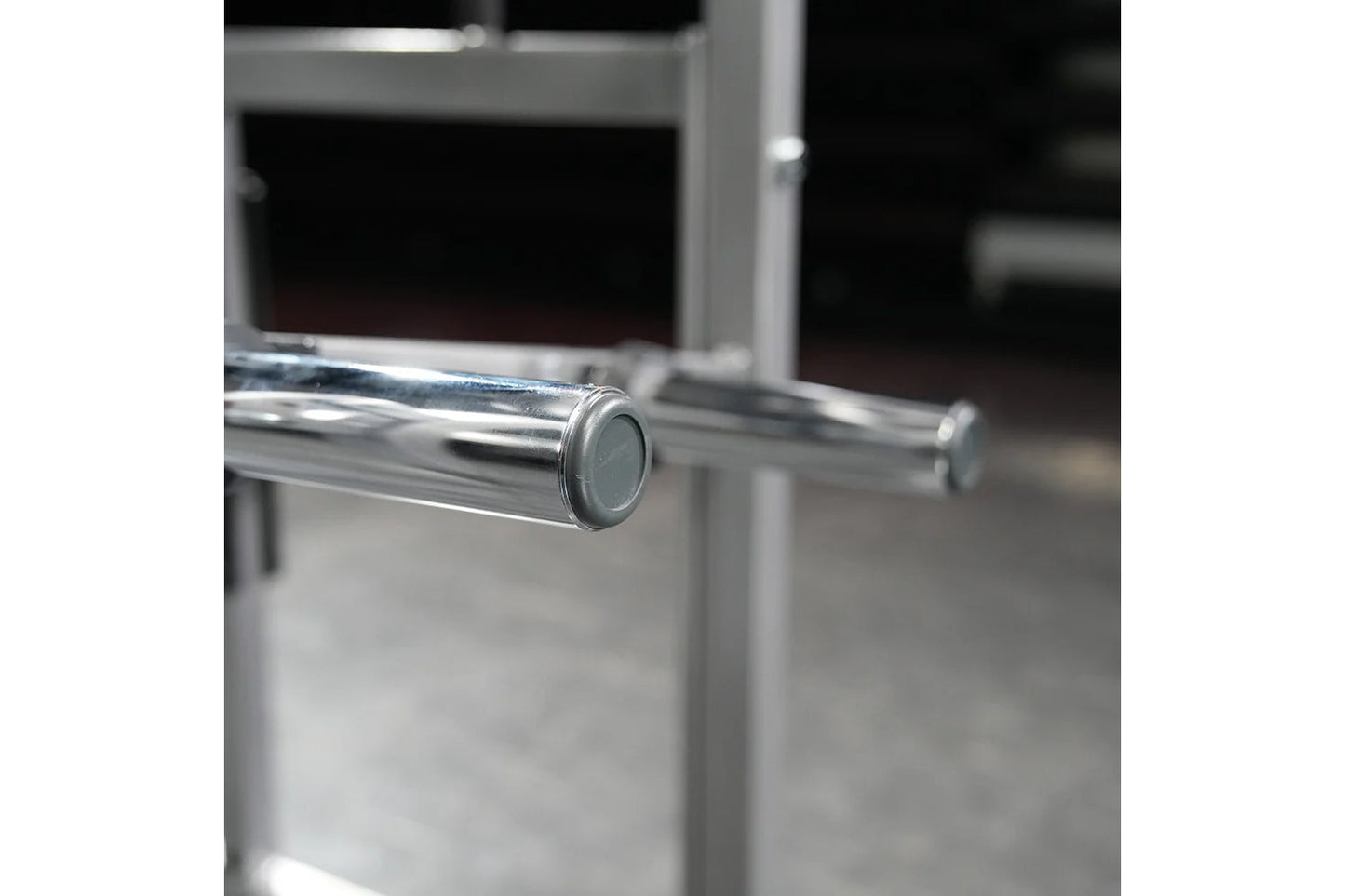 Polished chrome handle bar with gray end cap on Hammer Strength plate-loaded neck machine