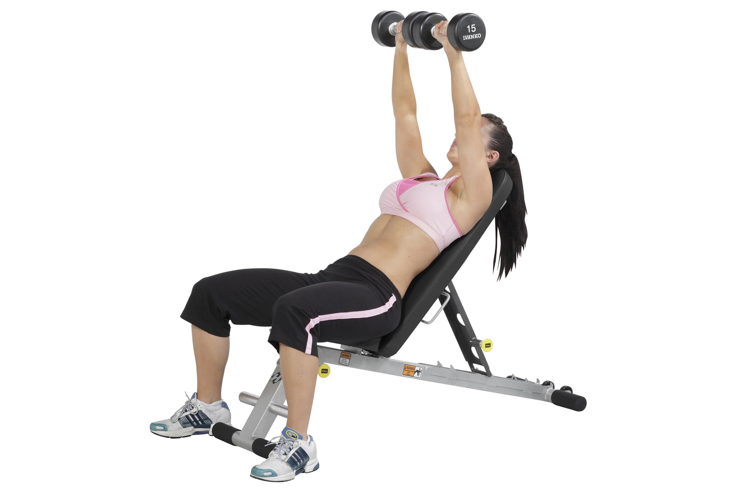 Woman performing dumbbell chest press on gray and black adjustable weight bench with 15kg dumbbells