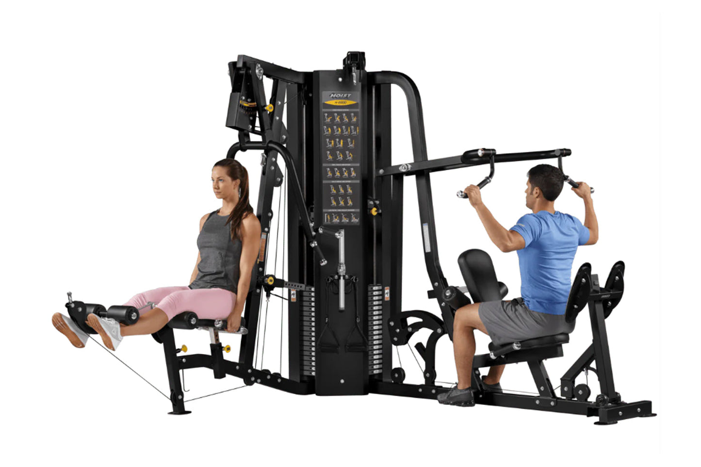 Hoist 2-Stack Multi Gym with black frame and yellow accents, demonstrating leg press and upper body exercises with two models