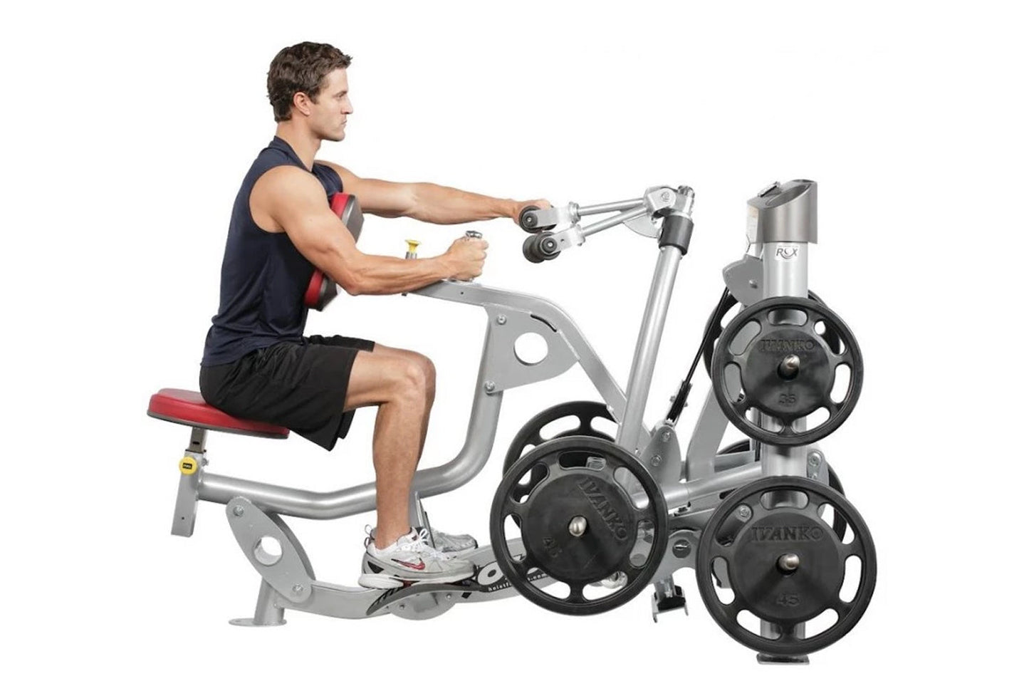 Man using silver Hoist ROC-IT biceps curl machine with black weight plates, demonstrating seated arm exercise on white backgr