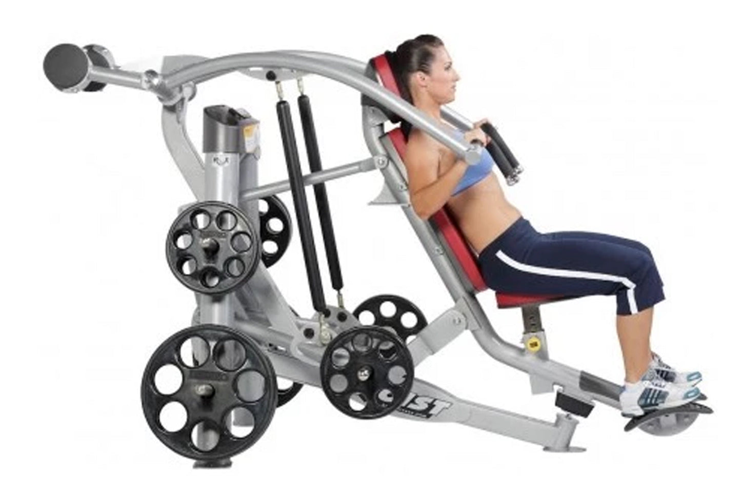 Woman using silver and black chest press machine with red back padding and weight plates, shown in profile on white backgroun