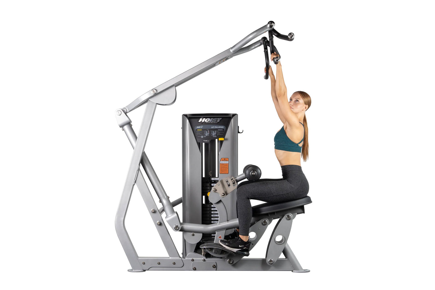 Hoist ROC-IT lat pulldown machine with silver frame and black seat, woman demonstrating proper form with teal sports bra and