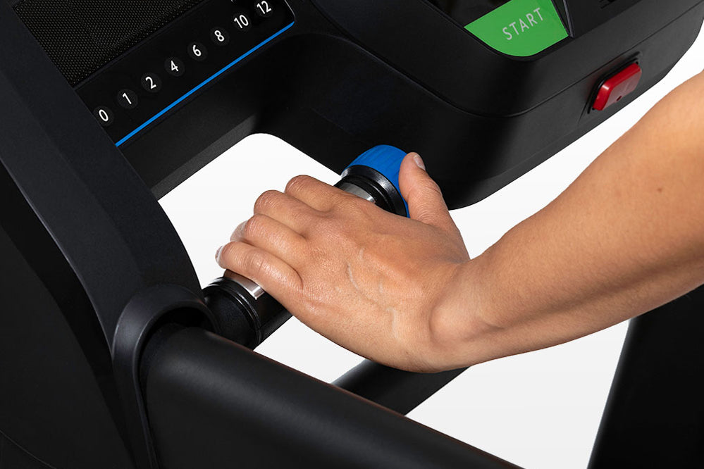 Hand gripping blue and black handlebar of Horizon T202 folding treadmill during use