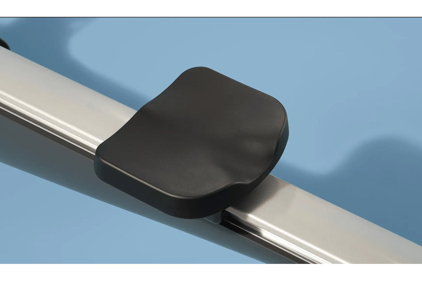 Black padded seat with silver metal rail on blue background