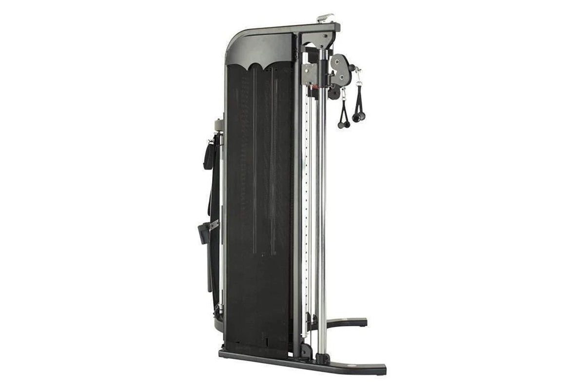 Inspire Fitness FT1 functional trainer with black pad and silver frame, dual cable pulleys and weight stacks on white backgro