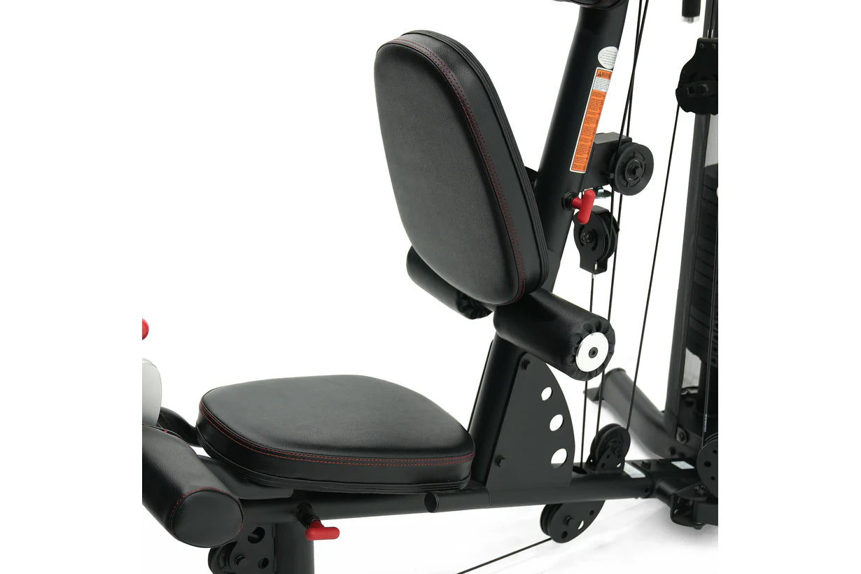 Black recumbent exercise bike with padded seat and backrest, red accents, and adjustable resistance cables on white backgroun