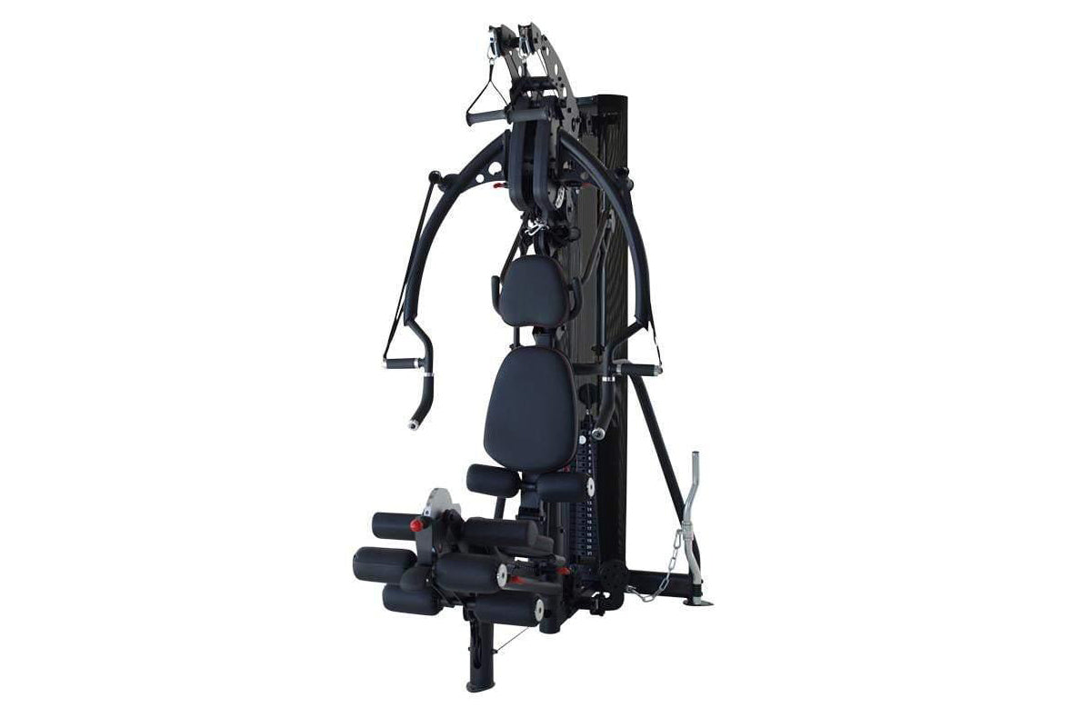 Black multi-gym system with padded seat, multiple resistance arms with handles, and leg press attachment on white background