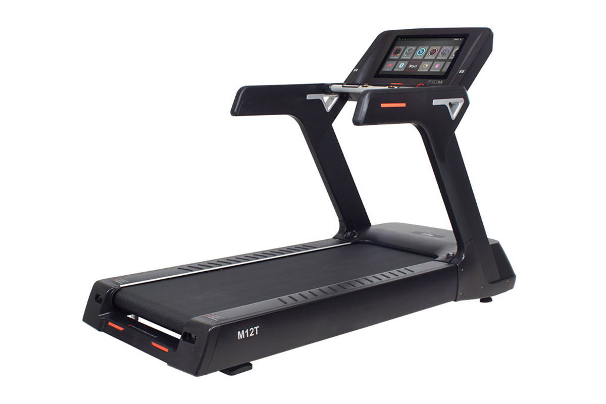 Black motorized treadmill with digital touchscreen console, gray handrails, and orange accent details, model M12T on white ba