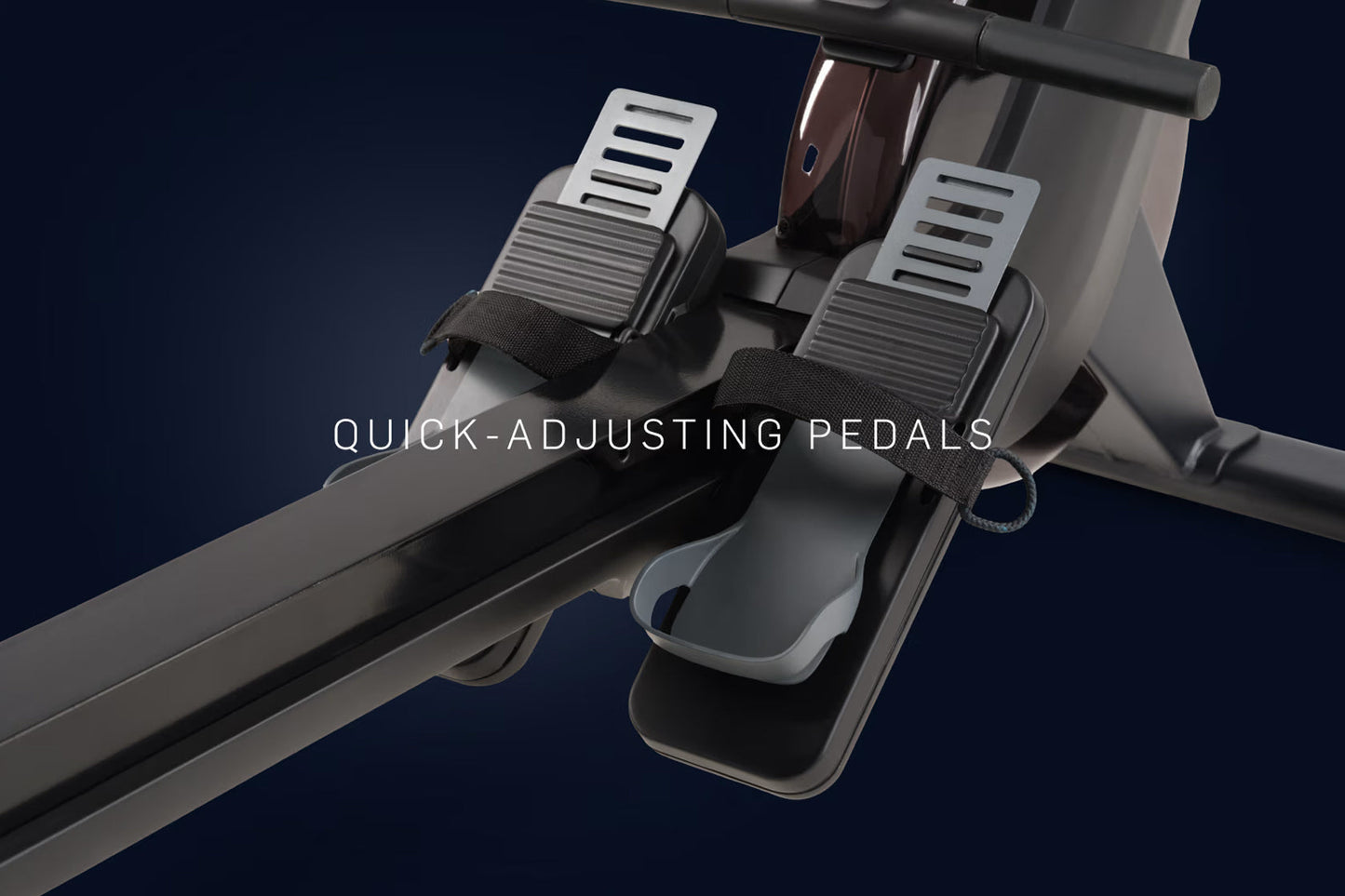 NordicTrack RW600 rowing machine pedals with white footplates, black straps, and black foot platform on dark blue background