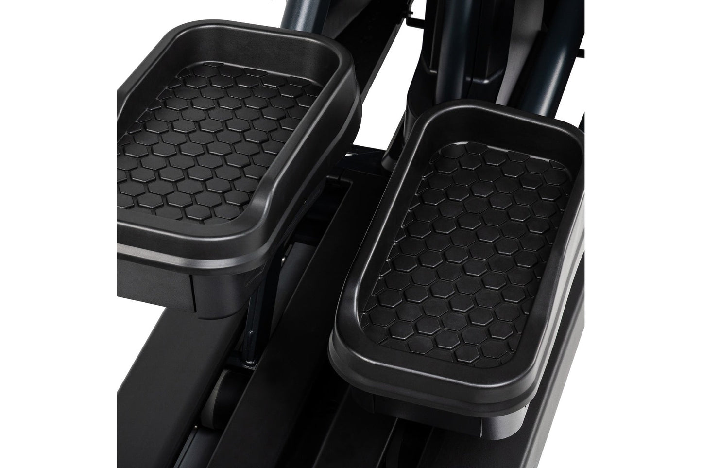Black hexagonal-patterned foot pedals on Spirit CE1000ENT elliptical machine, shown on white background