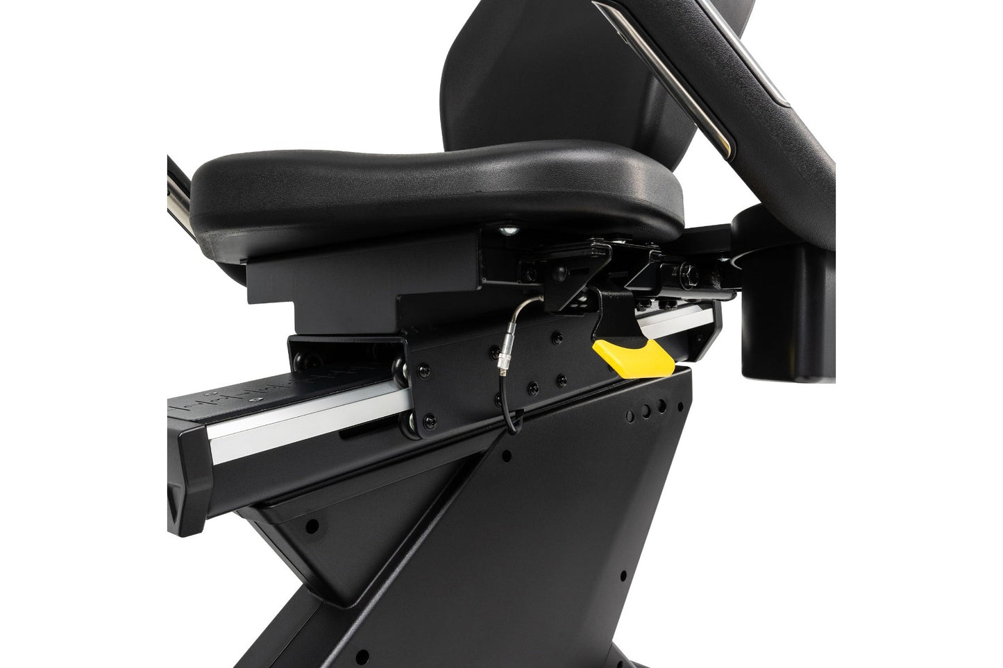 Black recumbent exercise bike with padded seat, foot pedals with yellow accent, and adjustable armrests on white background