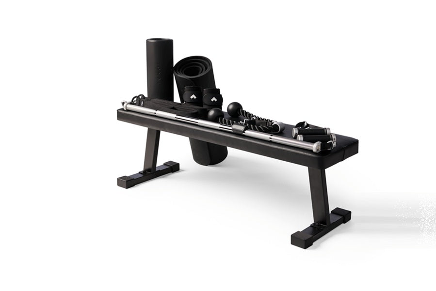 Black home gym equipment with adjustable arms, weights, and digital display mounted on steel frame against white background