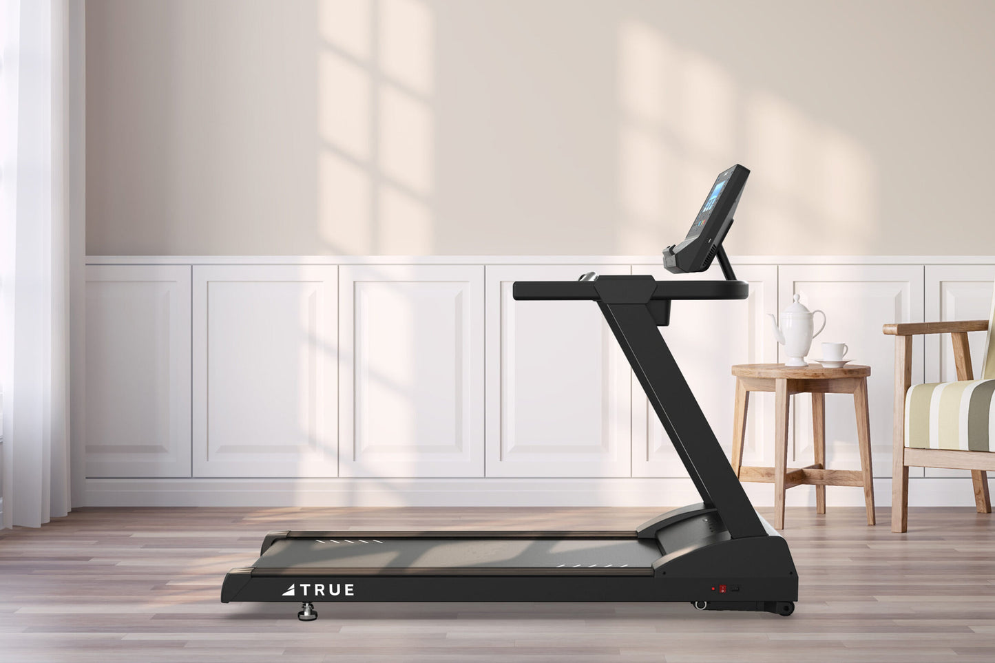 TRUE Z500 black treadmill with digital display and tablet holder, positioned in modern room with white paneling