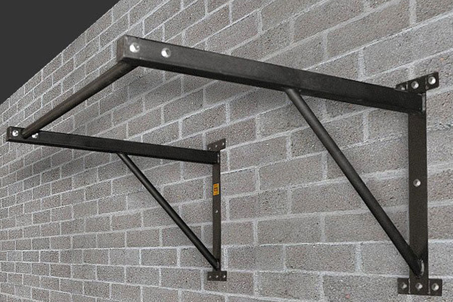 Black steel wall-mounted chin-up bar with diagonal braces, mounted on brick wall