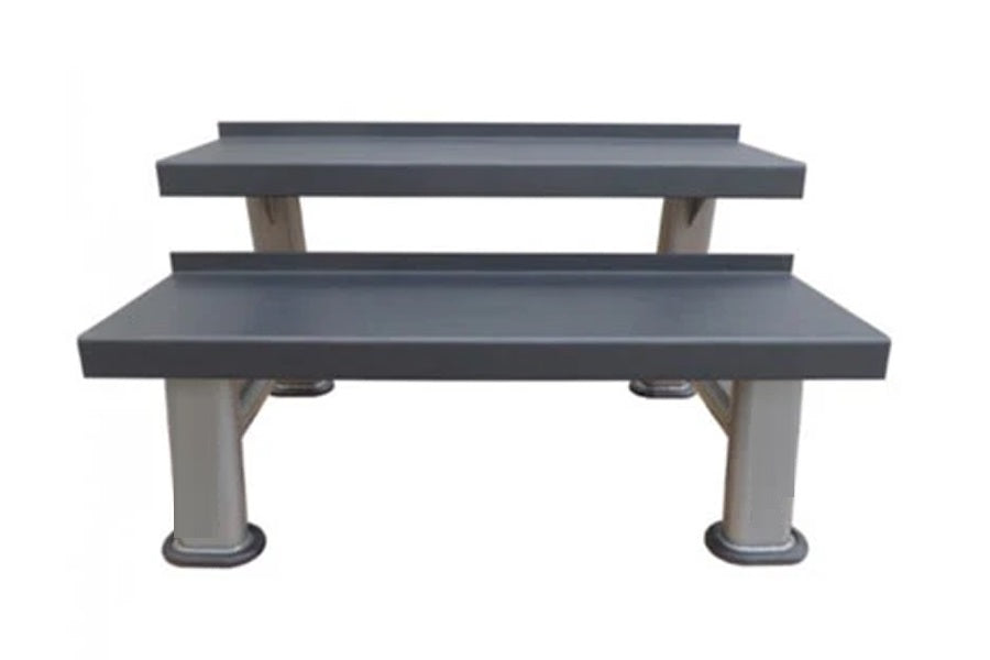 Two-tier commercial kettlebell rack with gray shelves and white cylindrical support legs on white background