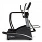 TRUE commercial elliptical with black frame, silver accents, dual handles, and foot pedals on white background