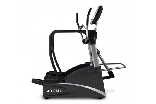 TRUE commercial elliptical with black frame, silver accents, dual handles, and foot pedals on white background