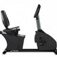 Black recumbent stationary bike with padded backrest, grey upright support, foot pedals, and digital console, shown on white 